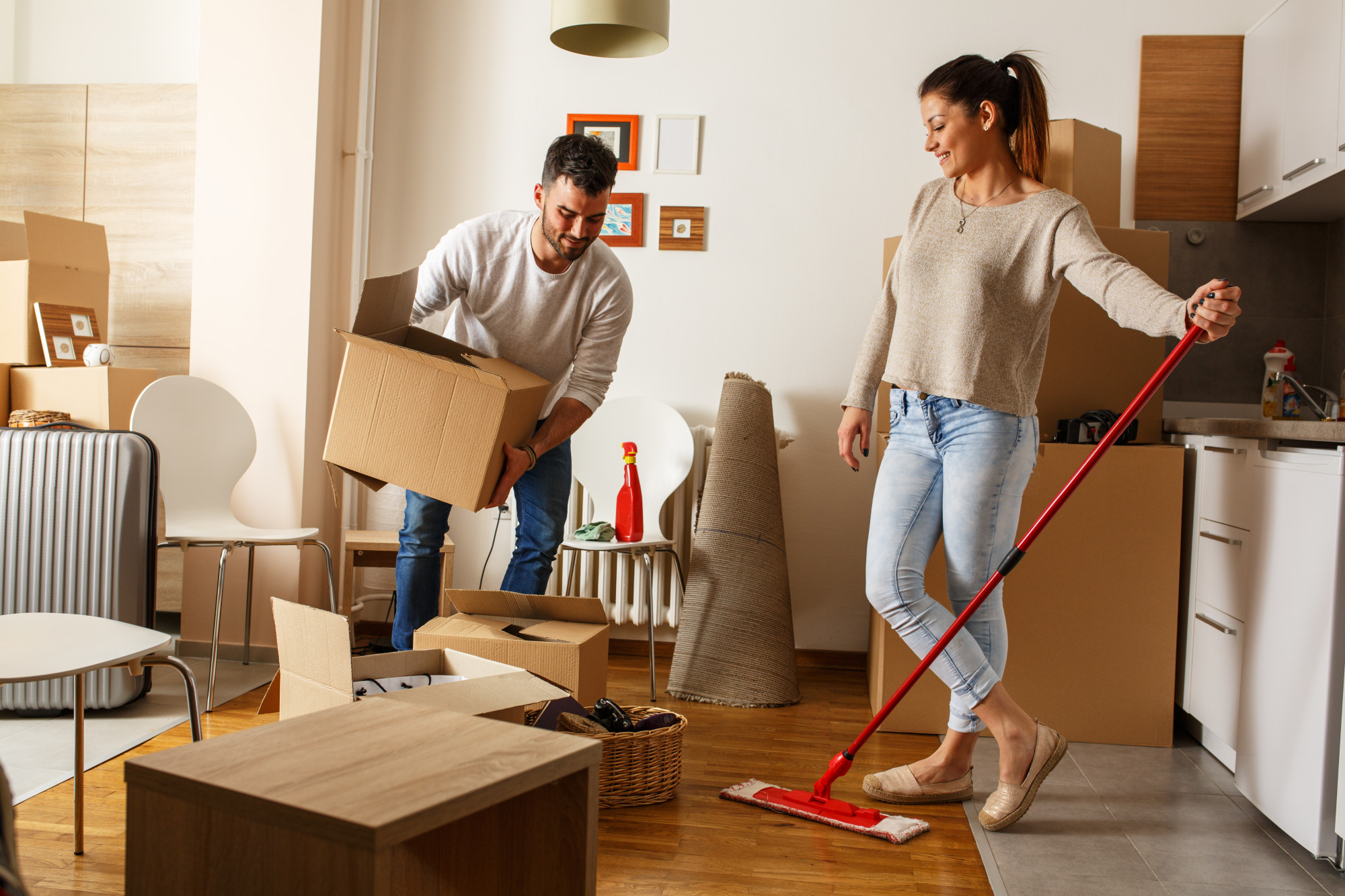 Young couple cleaning and selecting things at they new home.Moving house. Young couple cleaning and selecting things at they new home.Moving house.