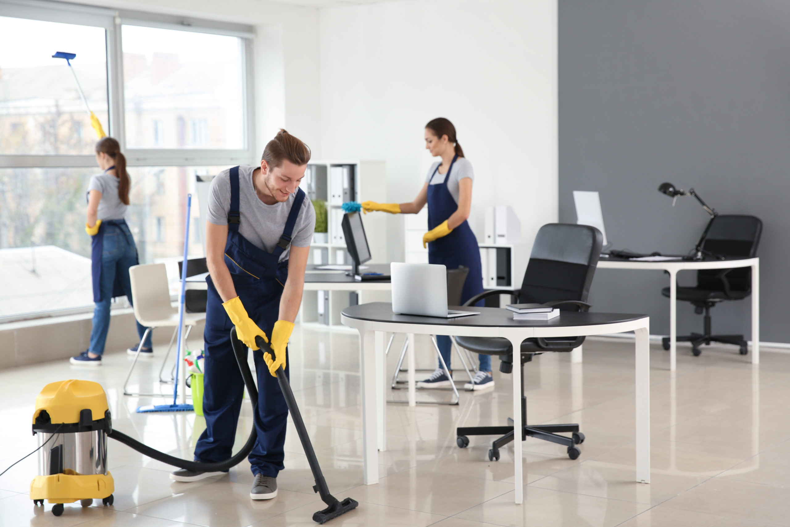 Team of janitors cleaning office Team of janitors cleaning office