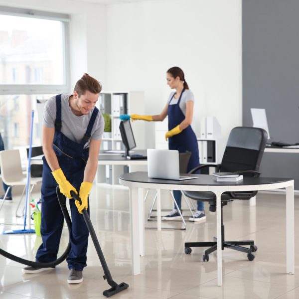 Team of janitors cleaning office
